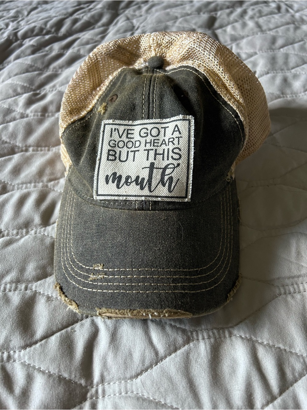 Distressed Black and Tan Trucker Hat with 'I've Got a Good Heart' Patch